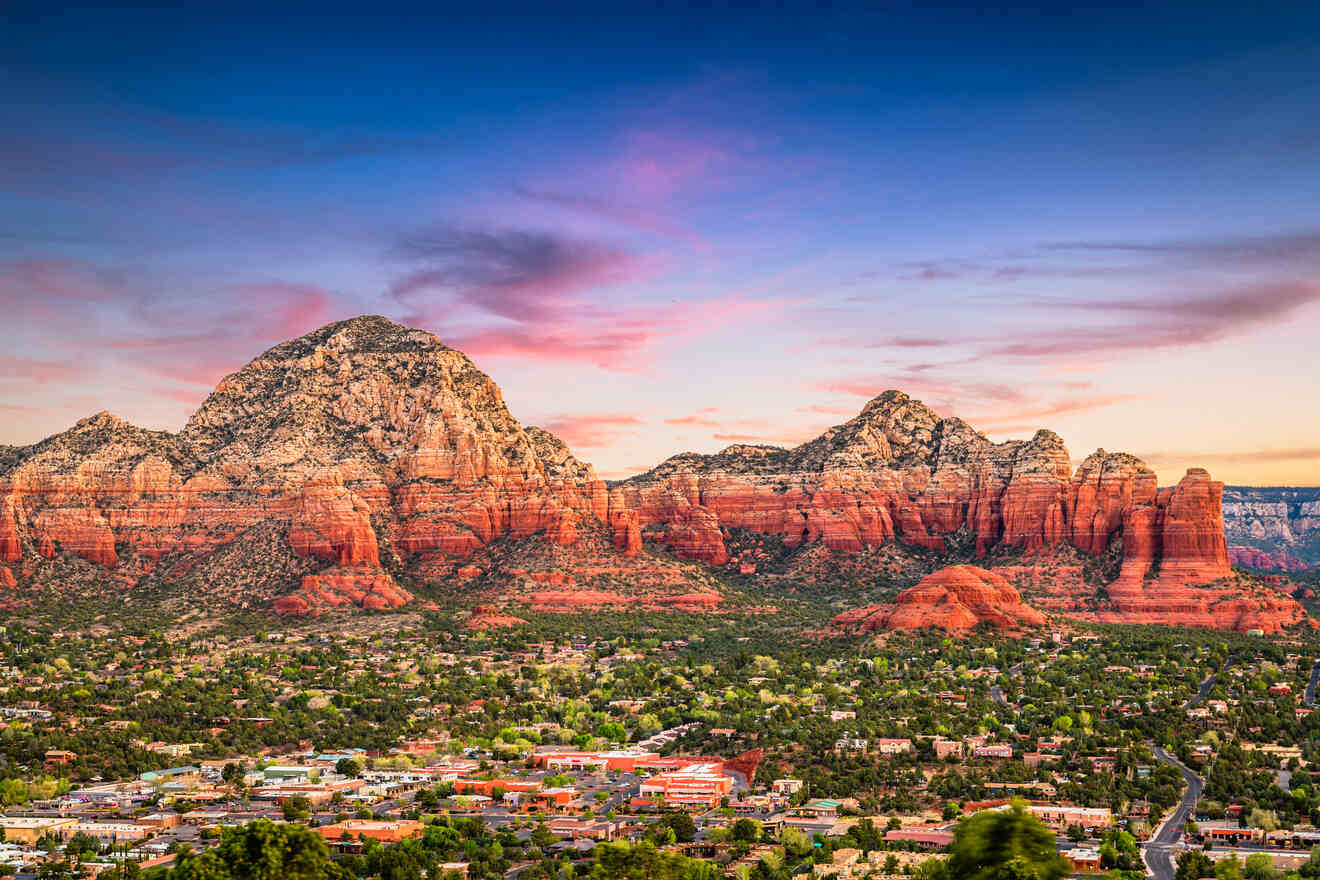 Dramatic sunset over Sedona, casting vibrant hues on the red rock mountains and overlooking the town's landscape